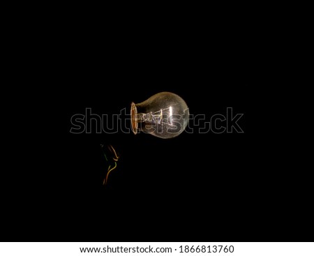 working lonely bulb with a pointed tip in the dark