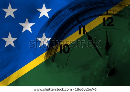 Solomon Islands flag with clock close to midnight in the background. Happy New Year concept