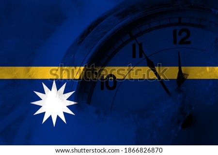 Nauru, Nauruan flag with clock close to midnight in the background. Happy New Year concept