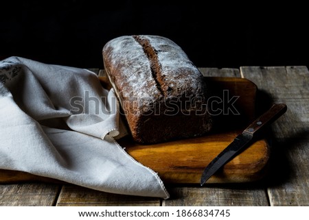 Freshly baked grain oats brown bread close up photos. Gastronomic photography.
Dark food  photography.