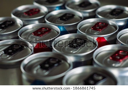 Shiny Silver Aluminum Soda Cans in a Group - red and blue - Closed cans close up - Many Drink tin can energy drink