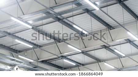 led lighting - big warehouse - energy saving |  production hall Royalty-Free Stock Photo #1866864049