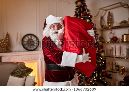 Santa Claus with a big red bag of gifts rush to bring present to children. New year and Merry Christmas , happy holidays concept