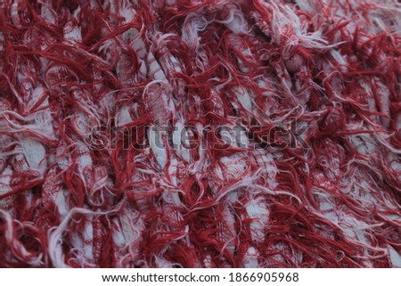 stacked red cloth crafts in such a way as to resemble dangling hair