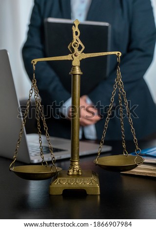 Office of Lawyer with Scales, laptop and documents on the workplace.