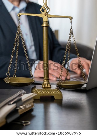Office of Lawyer with Scales, laptop and documents on the workplace.