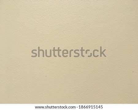 Light yellow smooth concrete wall texture background 