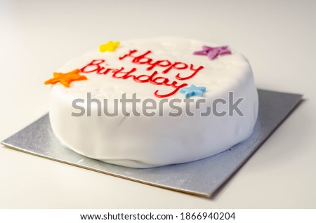 Happy Birthday Cake, Sponge cake layered with a sweet frosting and raspberry jam, decorated with soft icing decorations, celebration