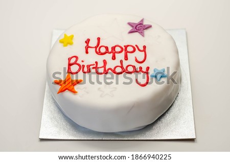Happy Birthday Cake, Sponge cake layered with a sweet frosting and raspberry jam, decorated with soft icing decorations, celebration