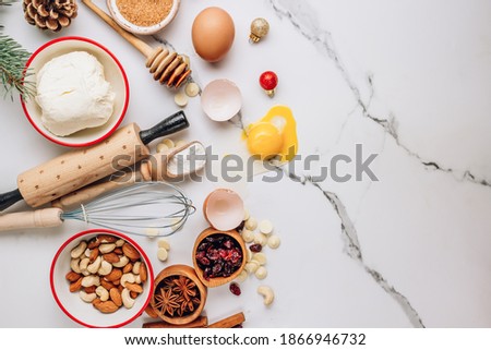 Christmas - baking cake background. Dough ingredients and decorations on white marble table. Kitchen layout with free text space. Top view. Flat lay