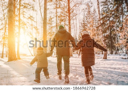 family walking in the woods in wintertime