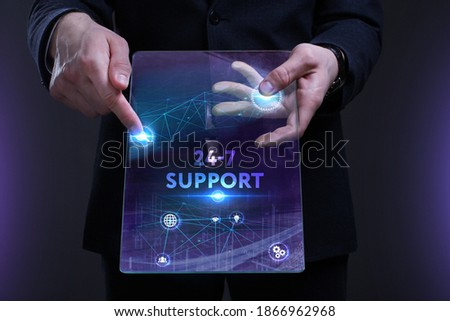 Business, Technology, Internet and network concept. Young businessman working on a virtual screen of the future and sees the inscription: 24-7 Support