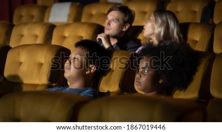Happy family watching movie in cinema theatre. Happy family time in holiday