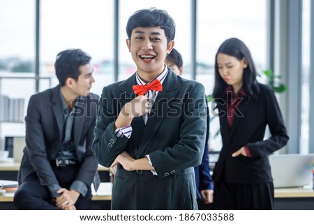 Successful company,executive Young Asian Homosexual businessman LGBT partners with happy workers Group of asian business people with diverse genders (LGBT) in the meeting room at office