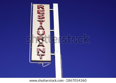 Restaurant light text sign on blue summer sky
