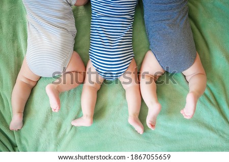 Newborn triplets lie on a stomach on the blanket Royalty-Free Stock Photo #1867055659