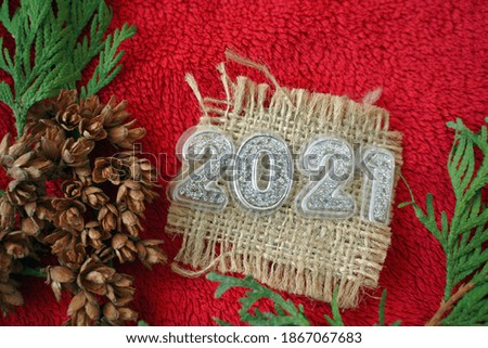 New year 2021 is coming celebration. Christmas decoration on red background. 2021 minimal creative holiday concept.                               