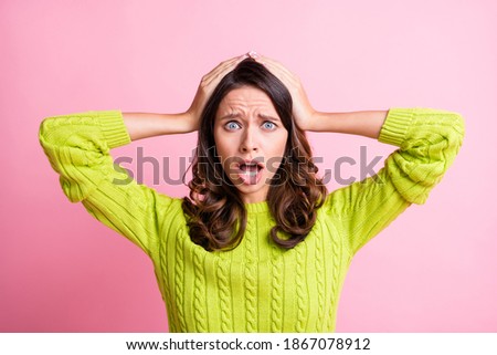 Photo of frightened anxious young girl open mouth palms head wear green pullover isolated pink color background