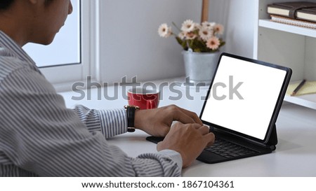 Cropped shot of male designer is working with computer tablet at his creative workspace.