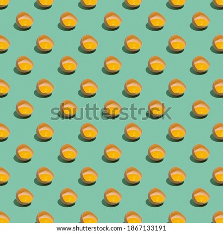 Pattern with broken eggs on a green background