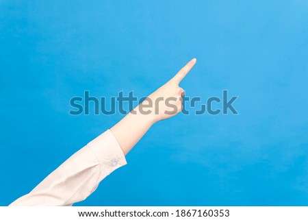 Close-up picture of woman's hand pointing a position with index finger