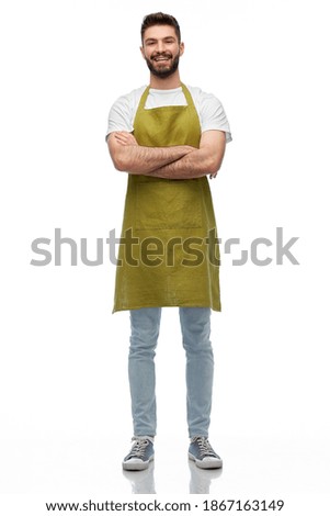 people, profession and job concept - happy smiling barman, waiter or gardener in apron with crossed arms over white background Royalty-Free Stock Photo #1867163149