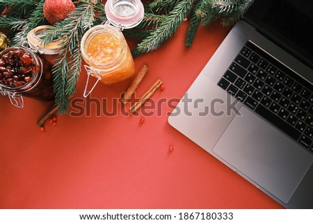 Closeup of a berry jam and laptop working from home on Christmas eve. Healthcare and protection. High quality photo