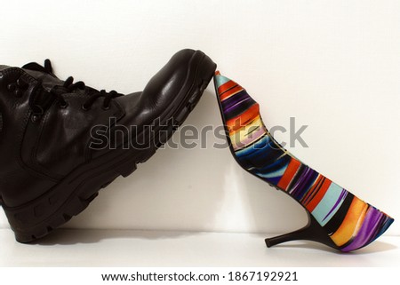 black rough men boot vs elegant multicolor women shoe Royalty-Free Stock Photo #1867192921