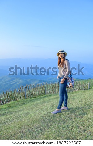 Woman Tourist with Doi Chang Mup Background at Chiang Rai Province, Thailand.