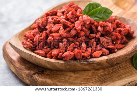 Goji in bowl on stone table.