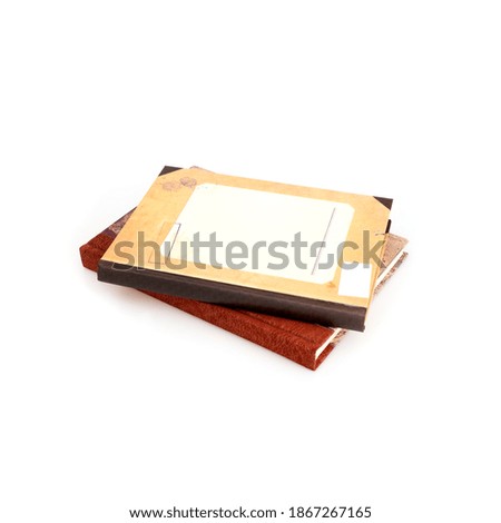 Stack of vintage books in colour covers isolated on a white background