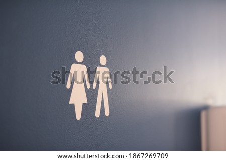 bathroom symbol of man and woman on blue door