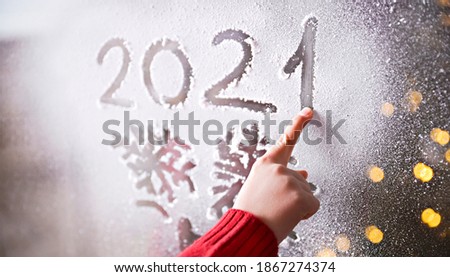 Original inscription of the year. Date 2021 in the snow. New year and christmas concept. 
