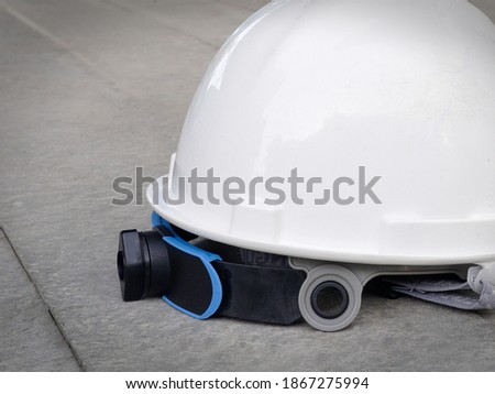 Isolated white hard hat on the floor 