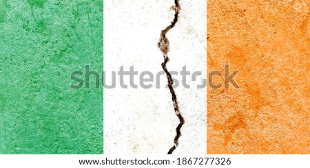 Grunge Ireland national flag icon isolated on weathered cracked concrete wall background, abstract vintage Irish political conflicts concept pattern texture wallpaper