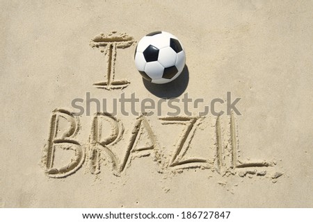 I love Brazil message with a soccer ball football handwritten in bright sunlight on sand beach