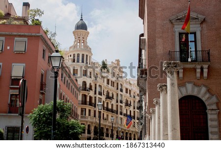 Exterior view of beautiful historical buildings in Central Madrid, Spain, Europe. Colorful street scene in the Chueca neighborhood of the Spanish capital. Royalty-Free Stock Photo #1867313440