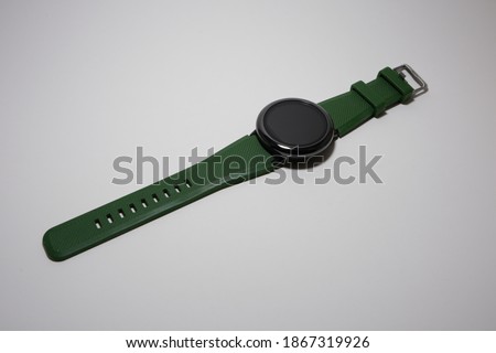 Touchscreen watch with green wristband isolated on a white background