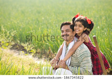 Happy father and daughter at agricultural field