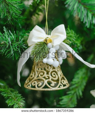 Christmas bell on green blurred background, christmas decoration for festive decor
