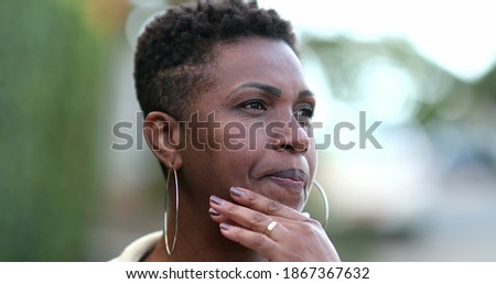 
Pensive African woman thinking. Contemplative black lady in deep think outside Royalty-Free Stock Photo #1867367632