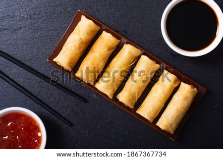 Asian food . Fried spring rolls with vegetables on rustic background Royalty-Free Stock Photo #1867367734