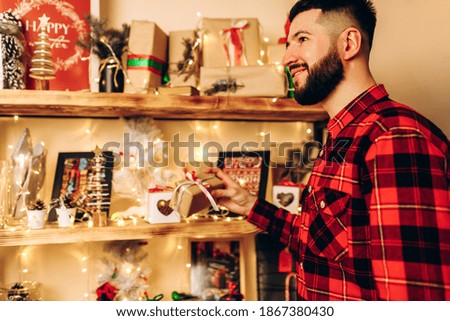 Christmas young man, in a plaid shirt, at home in a Christmas interior, Christmas, holiday
