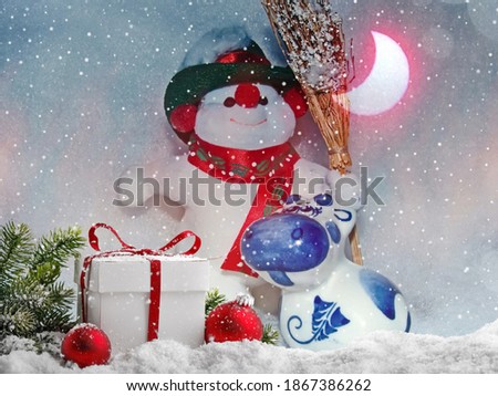 A cheerful snowman and Bull, the symbol of the 2021 new year, according to the eastern calendar in new year night. Happy Christmas and New year! Festive background. Holiday card