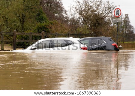 Two cars submerged in a flooded ford after heavy rain. December 2020. Much Hadham, Hertfordshire. UK Royalty-Free Stock Photo #1867390363