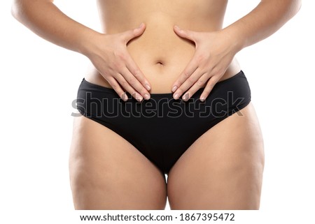 Love herself. Overweight woman with fat cellulite legs and buttocks, obesity female body in black underwear isolated on white background. Orange peel skin, liposuction, healthcare and beauty treatment