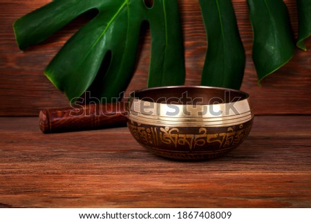Tibetan singing bowl. Tibetian inscription - mantra "Om mani padme hum" (Om is a sacred syllable. Mani means "jewel", Padme is the "lotus flower", and Hum represents spirit of enlighment)