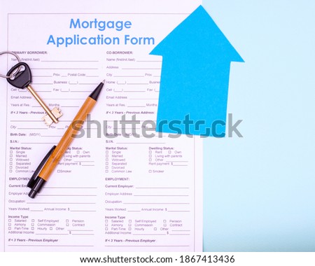 Real estate purchase, mortgage concept. Flat lay mortgage application form, pen and keys to future house or apartment on blue background, top view, copy space