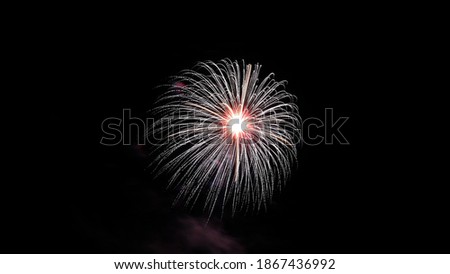 Light painting. Neon glow. Symmetry and reflection. colored  fireworks in the night sky. Abstract blurred background Purple festive firecracker.  Glowing texture. Shining pattern.
