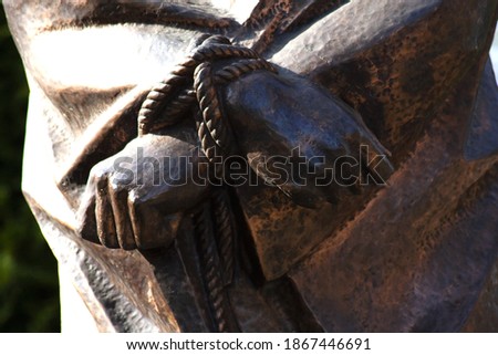 Hands tied with a rope of Jesus Cross, part of the statue. For Religion backgrounds